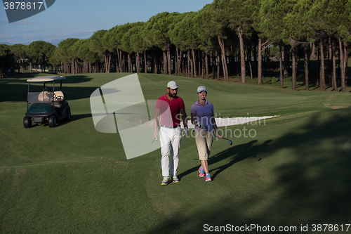 Image of couple walking on golf course