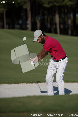 Image of golfer hitting a sand bunker shot