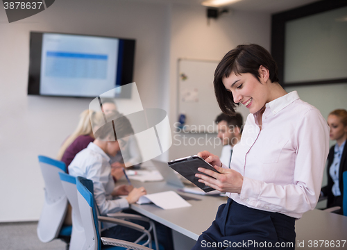 Image of business woman on meeting  using tablet