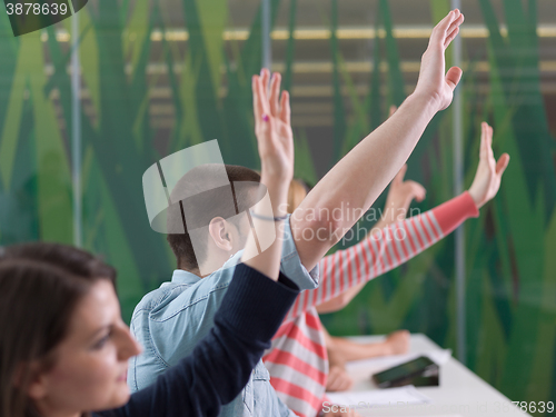 Image of students group raise hands up on class