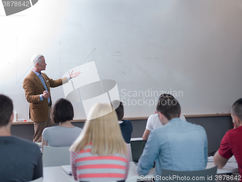Image of teacher with a group of students in classroom