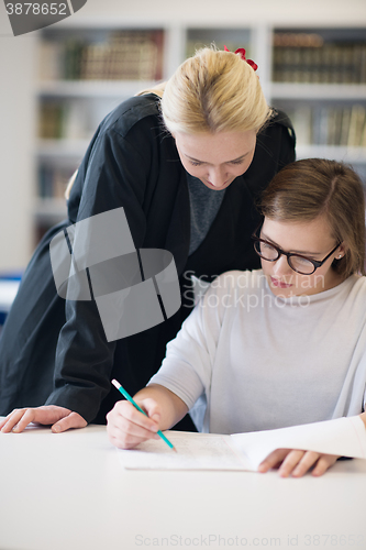Image of female teacher helping students on class