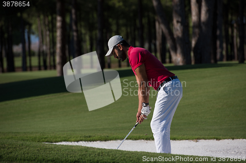 Image of golfer hitting a sand bunker shot