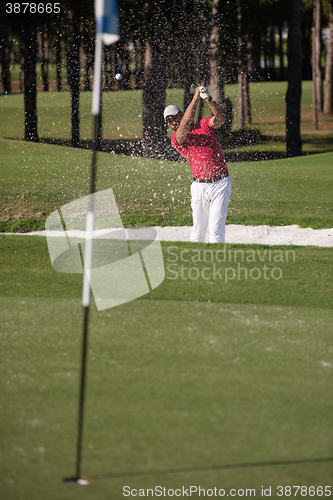 Image of golfer hitting a sand bunker shot