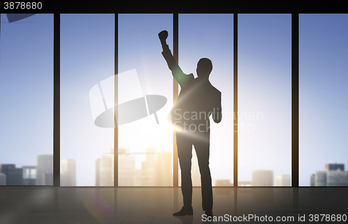 Image of silhouette of business man over office background