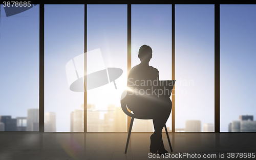 Image of silhouette of business woman with laptop