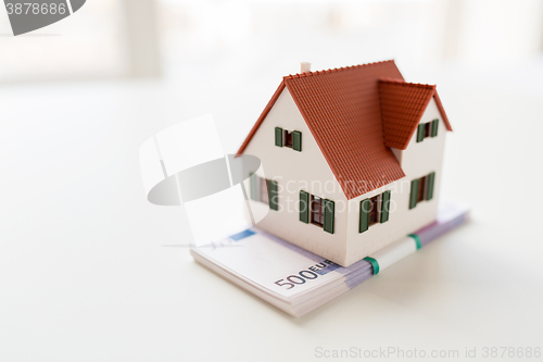 Image of close up of home or house model and money