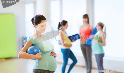 Image of happy pregnant woman with ball in gym