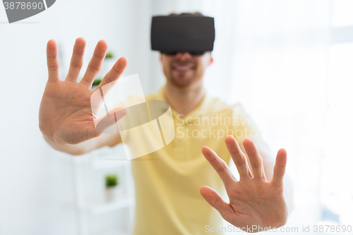 Image of young man in virtual reality headset or 3d glasses