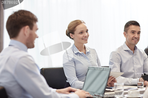 Image of smiling business people with tablet pc in office