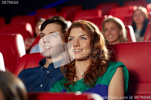 Image of happy friends watching movie in theater