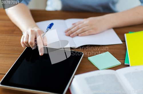 Image of close up of student with tablet pc and notebook