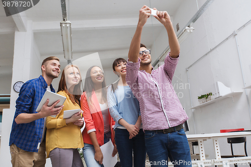 Image of creative business team taking selfie at office