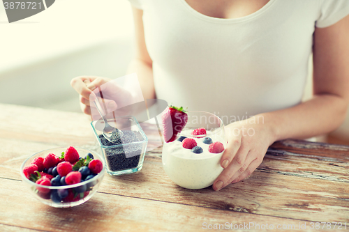 Image of close up of woman hands with yogurt and berries