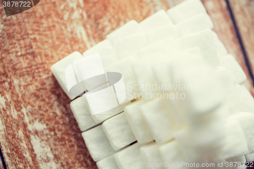 Image of close up of white sugar pyramid on wooden table