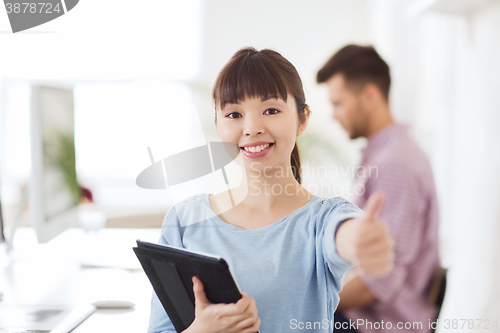 Image of happy creative female office worker with tablet pc
