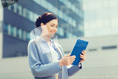 Image of smiling business woman with tablet pc in city