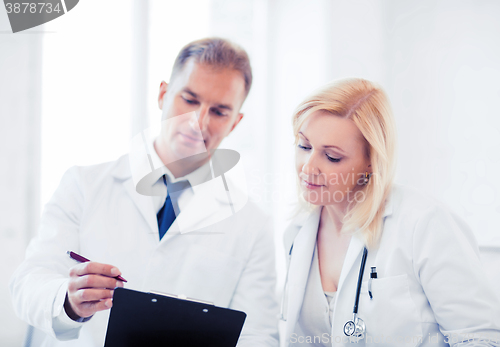 Image of two doctors writing prescription