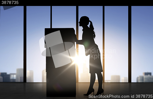 Image of silhouette of businesswoman moving boxes at office