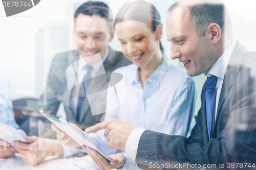 Image of business team with tablet pc having discussion