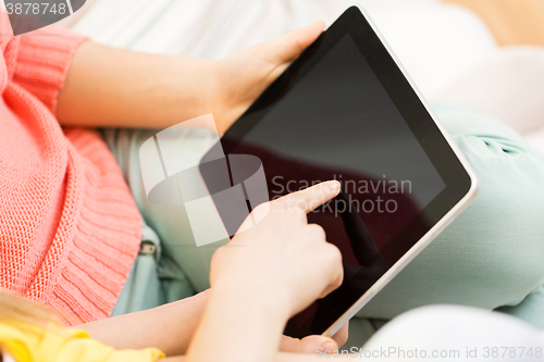 Image of close up of young women with tablet pc at home