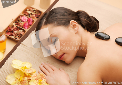 Image of beautiful woman with hot stones