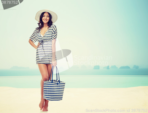 Image of happy young woman in summer clothes and sun hat