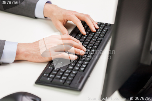Image of close up of businessman hands typing on keyboard
