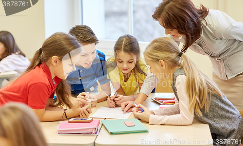 Image of group of school kids writing test in classroom