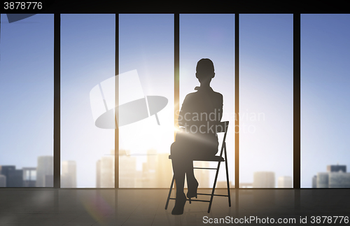 Image of silhouette of business woman sitting on chair