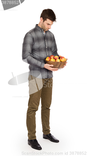 Image of Healthy man with bowl full of apples