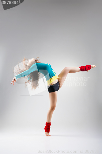 Image of Modern style dancer  posing on grey background