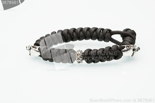 Image of Black braided bracelet with skulls on white background