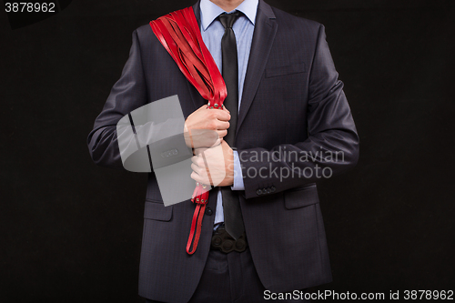 Image of man in business suit with chained hands. handcuffs for sex games