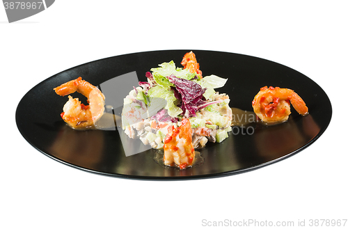 Image of perfect dish with shrimps on a black plate. seafood. Isolated  white background