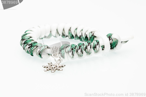 Image of green braided bracelet on white background. snowflake