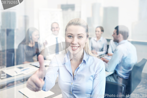 Image of group of smiling businesspeople meeting in office