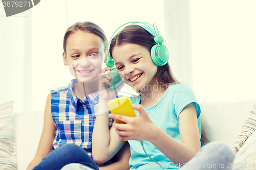 Image of happy girls with smartphone and headphones