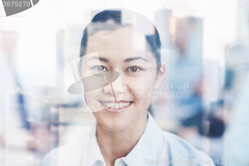 Image of group of smiling businesspeople meeting in office