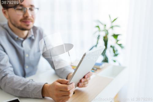 Image of happy creative male office worker with tablet pc