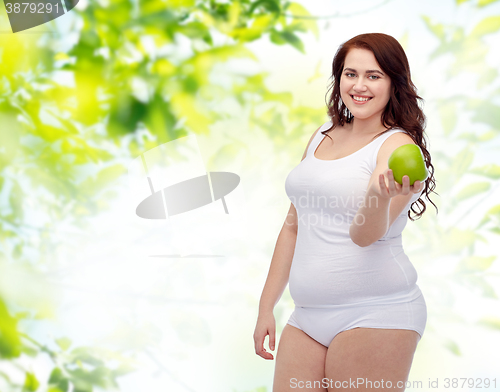 Image of happy plus size woman in underwear with apple