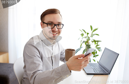 Image of happy businessman with smarphone and coffee