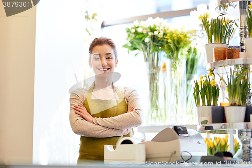 Image of smiling florist woman at flower shop cashbox