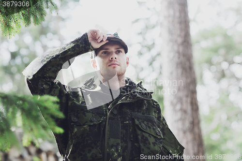 Image of young soldier or ranger in forest