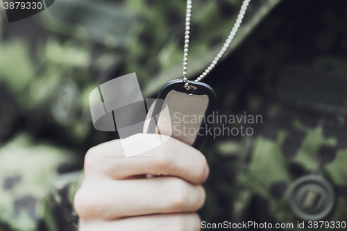 Image of close up of young soldier in military uniform