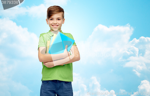 Image of happy student boy with folders and notebooks