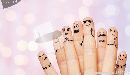 Image of close up of hands and fingers with smiley faces