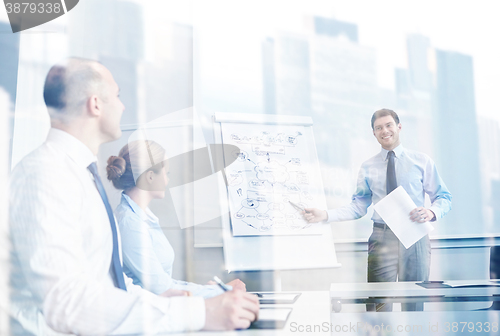 Image of group of smiling businesspeople meeting in office