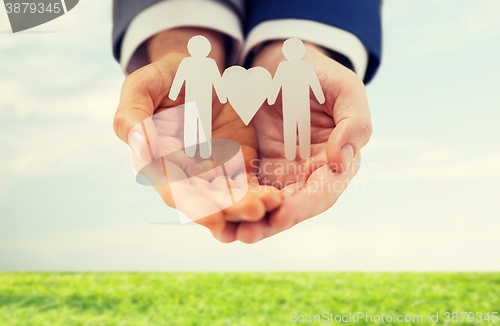 Image of close up of male gay couple with love symbol