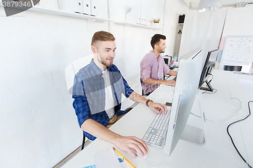 Image of creative man or student with computer at office